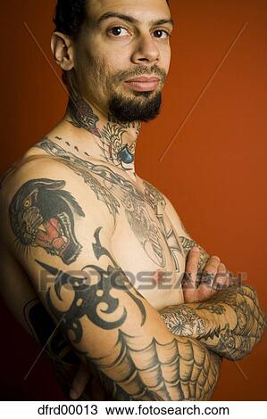 Man with tattoos and crossed arms View Large Photo Image Stock Image - Man with tattoos and crossed arms. Fotosearch