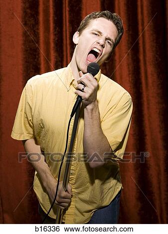 Man yelling or singing into microphone View Large Photo Image Stock Photograph - Man yelling or singing into microphone. Fotosearch