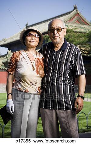 Mature couple embracing outdoors with pagoda in background View Large Photo Image Stock Photography - Mature couple embracing outdoors with pagoda in background. Fotosearch