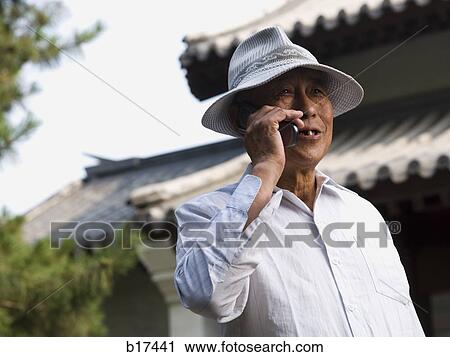 Mature man talking on cell phone outdoors smiling View Large Photo Image Stock Image - Mature man talking on cell phone outdoors smiling. Fotosearch