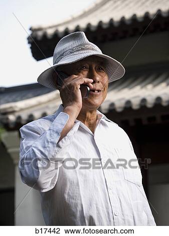 Mature man talking on cell phone outdoors smiling View Large Photo Image Stock Image - Mature man talking on cell phone outdoors smiling. Fotosearch