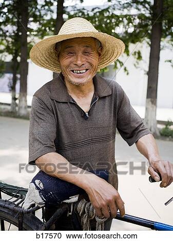 Mature man with straw hat outdoors with bicycle smiling View Large Photo Image Stock Image - Mature man with straw hat outdoors with bicycle smiling. Fotosearch