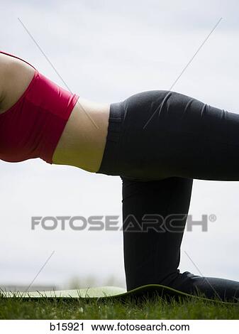 Mid section of woman kneeling and stretching outdoors View Large Photo Image Stock Image - Mid section of woman kneeling and stretching outdoors. Fotosearch