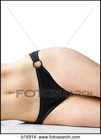 Mid-section view of woman in bikini lying down View Large Photo Image Picture - Mid-section view of woman in bikini lying down. Fotosearch