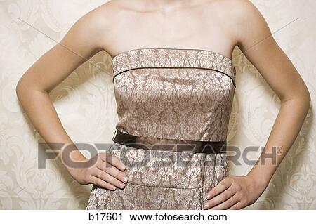Mid section view of woman in dress with hands on hips View Large Photo Image Stock Image - Mid section view of woman in dress with hands on hips. Fotosearch