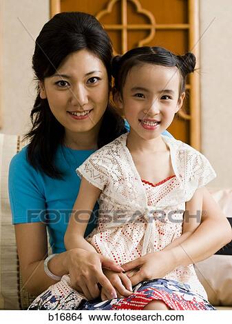 Mother and daughter embracing and smiling View Large Photo Image Picture - Mother and daughter embracing and smiling. Fotosearch