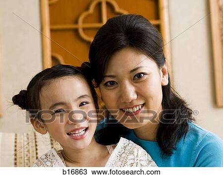 Mother and daughter embracing and smiling View Large Photo Image Stock Image - Mother and daughter embracing and smiling. Fotosearch