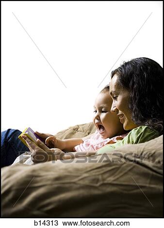 Stock Image - Mother and daughter reading.. Fotosearch