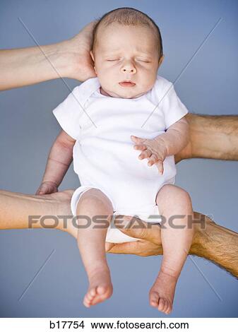 Picture - Mother and Father holding Newborn baby.. Fotosearch