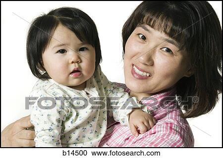 Stock Image - Mother holding daughter. Fotosearch