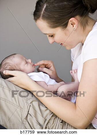 Stock Photo - Mother holding newborn baby.. Fotosearch
