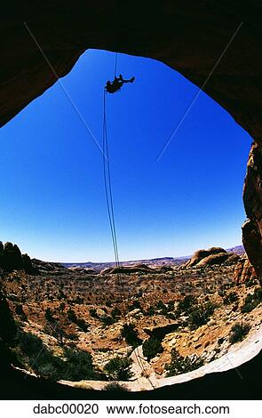 Mountain climber hanging with ropes and blue sky View Large Photo Image Stock Image - Mountain climber hanging with ropes and blue sky. Fotosearch