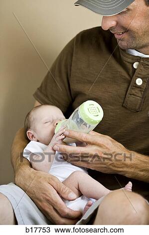 Stock Image - Newborn baby drinking from bottle.. Fotosearch