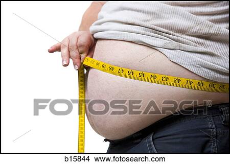 Obese man measuring waist with tape measure View Large Photo Image Picture - Obese man measuring waist with tape measure. Fotosearch