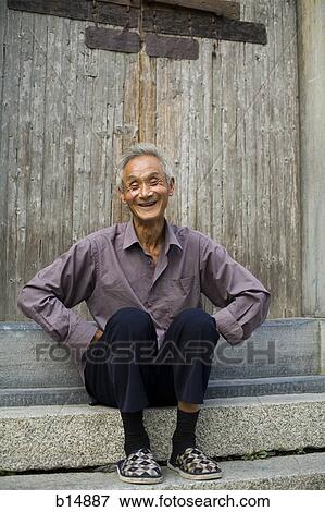 Stock Photo - Old man sitting outdoors smiling. Fotosearch