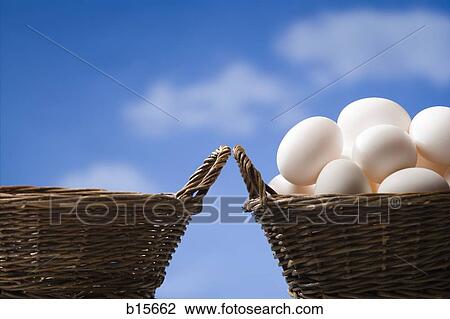 One empty basket and one basket filled with eggs outdoors with blue sky View Large Photo Image Stock Image - One empty basket and one basket filled with eggs outdoors with blue sky. Fotosearch
