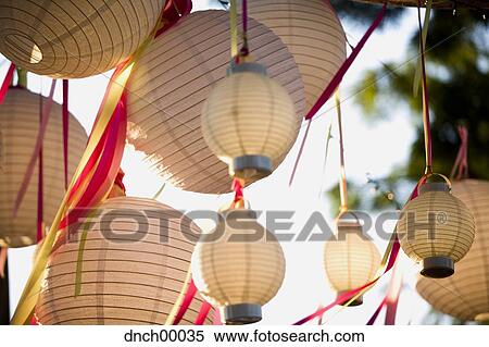 Stock Photography - Paper lanterns and ribbons hanging outdoors. Fotosearch