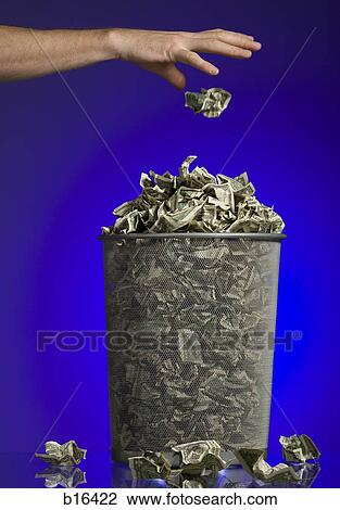 Person throwing crumpled money into waste paper basket View Large Photo Image Stock Image - Person throwing crumpled money into waste paper basket. Fotosearch