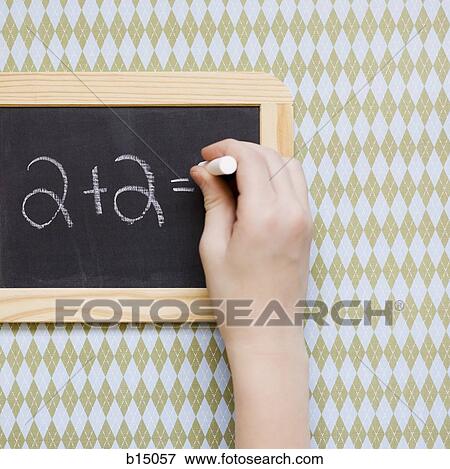 Stock Photo - Person writing numbers on blackboard with chalk. Fotosearch