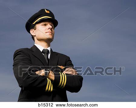 Pilot standing with arms crossed outdoors View Large Photo Image Stock Image - Pilot standing with arms crossed outdoors. Fotosearch
