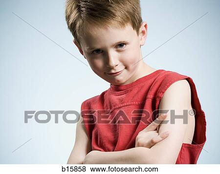 Stock Photo - Portrait of a boy making hand gesture smiling. Fotosearch
