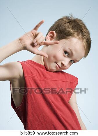 Portrait of a boy making hand gesture View Large Photo Image Stock Photo - Portrait of a boy making hand gesture. Fotosearch