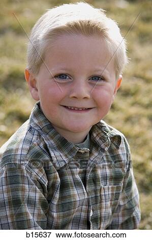 Stock Photo - Portrait of a boy smiling outdoors. Fotosearch