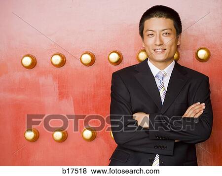 Portrait of a businessman with arms crossed smiling View Large Photo Image Stock Photo - Portrait of a businessman with arms crossed smiling. Fotosearch