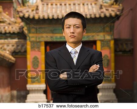 Stock Photo - Portrait of a businessman with arms crossed outdoors. Fotosearch