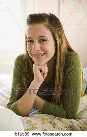 Portrait of a girl with braces smiling View Large Photo Image Stock Photo - Portrait of a girl with braces smiling. Fotosearch