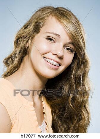 Portrait of a girl with braces smiling View Large Photo Image Stock Photo - Portrait of a girl with braces smiling. Fotosearch