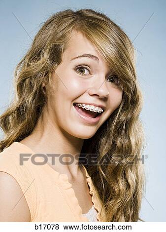 Portrait of a girl with braces smiling View Large Photo Image Stock Photo - Portrait of a girl with braces smiling. Fotosearch