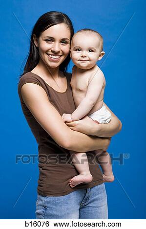 Portrait of a woman holding baby smiling View Large Photo Image Stock Photograph - Portrait of a woman holding baby smiling. Fotosearch