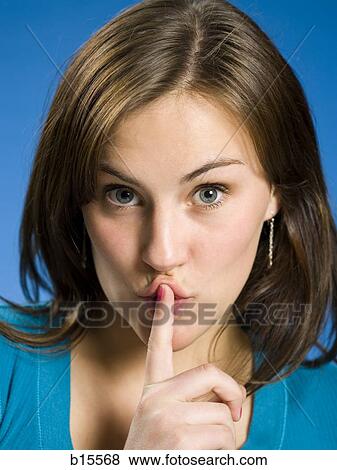Portrait of a woman hushing View Large Photo Image Stock Photo - Portrait of a woman hushing. Fotosearch