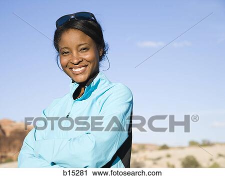 Stock Image - Portrait of a woman smiling outdoors. Fotosearch