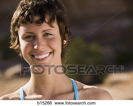 Portrait of a woman smiling outdoors View Large Photo Image Stock Photograph - Portrait of a woman smiling outdoors. Fotosearch