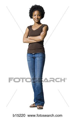 Portrait of a woman standing with arms crossed View Large Photo Image Stock Image - Portrait of a woman standing with arms crossed. Fotosearch