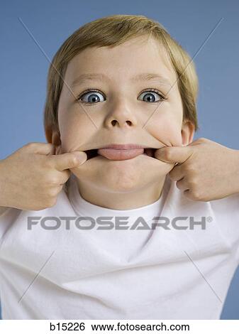 Portrait of boy sticking tongue out View Large Photo Image Stock Photograph - Portrait of boy sticking tongue out. Fotosearch