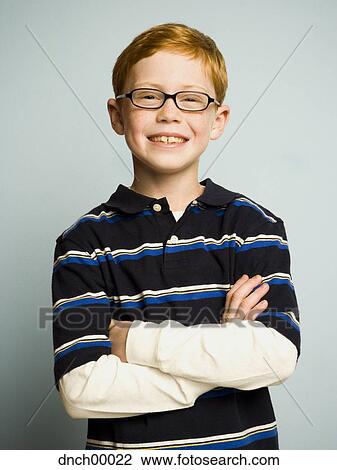 Portrait of boy with eyeglasses and arms crossed smiling View Large Photo Image Stock Image - Portrait of boy with eyeglasses and arms crossed smiling. Fotosearch