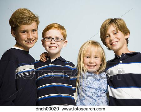 Stock Image - Portrait of three boys and girl smiling. Fotosearch