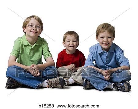 Portrait of three boys sitting cross legged View Large Photo Image Stock Photo - Portrait of three boys sitting cross legged. Fotosearch