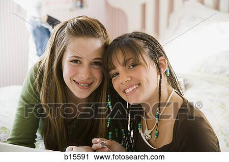 Stock Image - Portrait of two girls smiling. Fotosearch