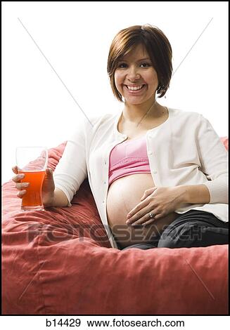 Pregnant Woman holding drinking glass. View Large Photo Image Stock Photo - Pregnant Woman holding drinking glass.. Fotosearch