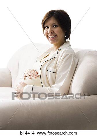 Picture - Pregnant Woman holding stomach.. Fotosearch