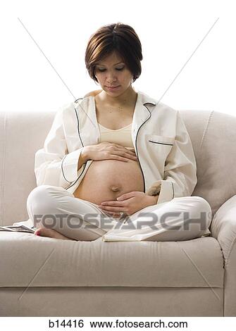Pregnant Woman holding stomach. View Large Photo Image Stock Photograph - Pregnant Woman holding stomach.. Fotosearch