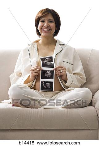 Pregnant Woman looking at pictures. View Large Photo Image Stock Photography - Pregnant Woman looking at pictures.. Fotosearch