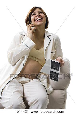 Stock Image - Pregnant Woman on the phone.. Fotosearch