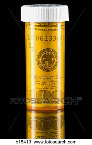 Prescription bottle with one hundred dollar bill inside View Large Photo Image Stock Photo - Prescription bottle with one hundred dollar bill inside. Fotosearch