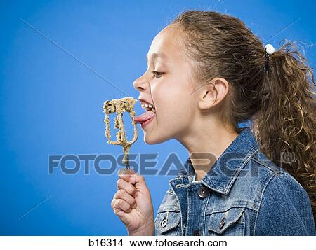 Profile of girl licking batter off beater View Large Photo Image Picture - Profile of girl licking batter off beater. Fotosearch