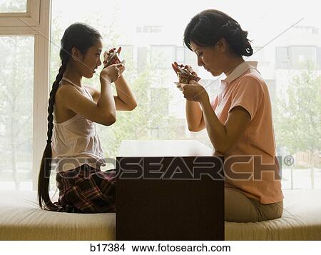 Profile of woman and girl sitting cross legged in front of large window View Large Photo Image Picture - Profile of woman and girl sitting cross legged in front of large window. Fotosearch
